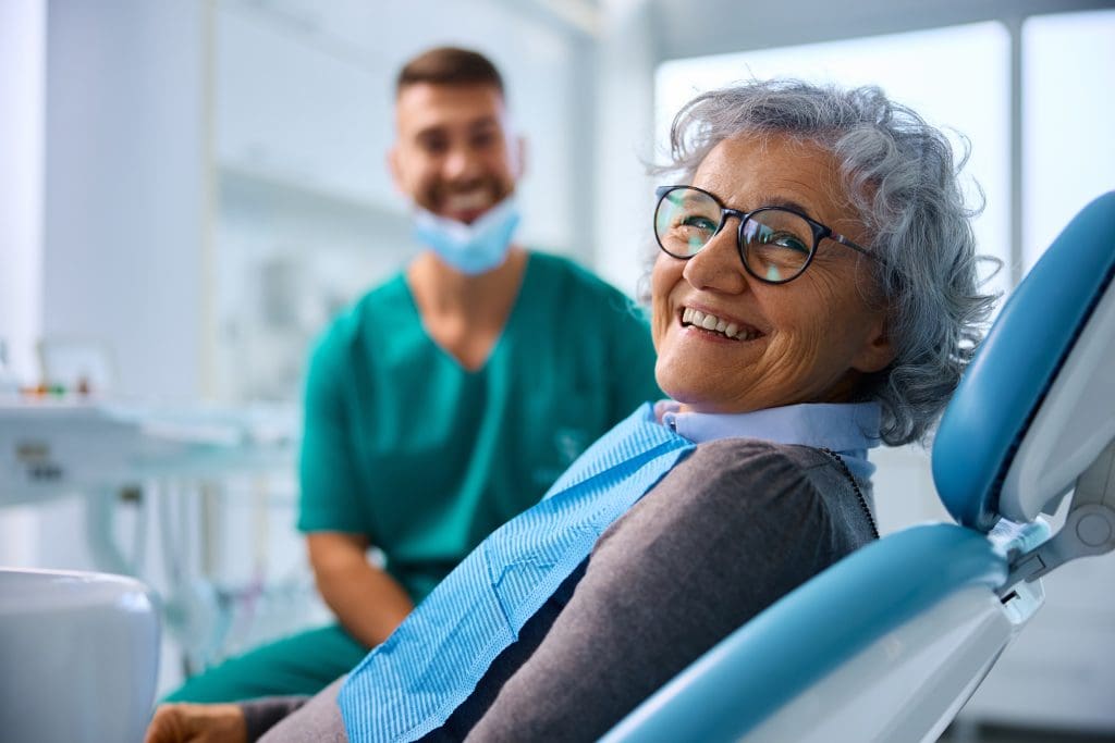 smiling senior woman, happy with new dental bridge